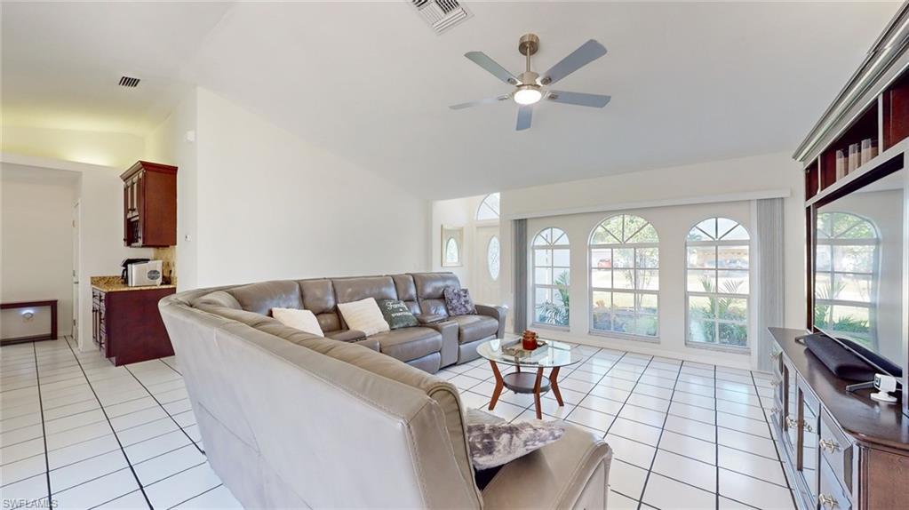 18249 Lee Road Fort Myers, FL 33967 - Photo 5 of 31 a living room with furniture and a flat screen tv