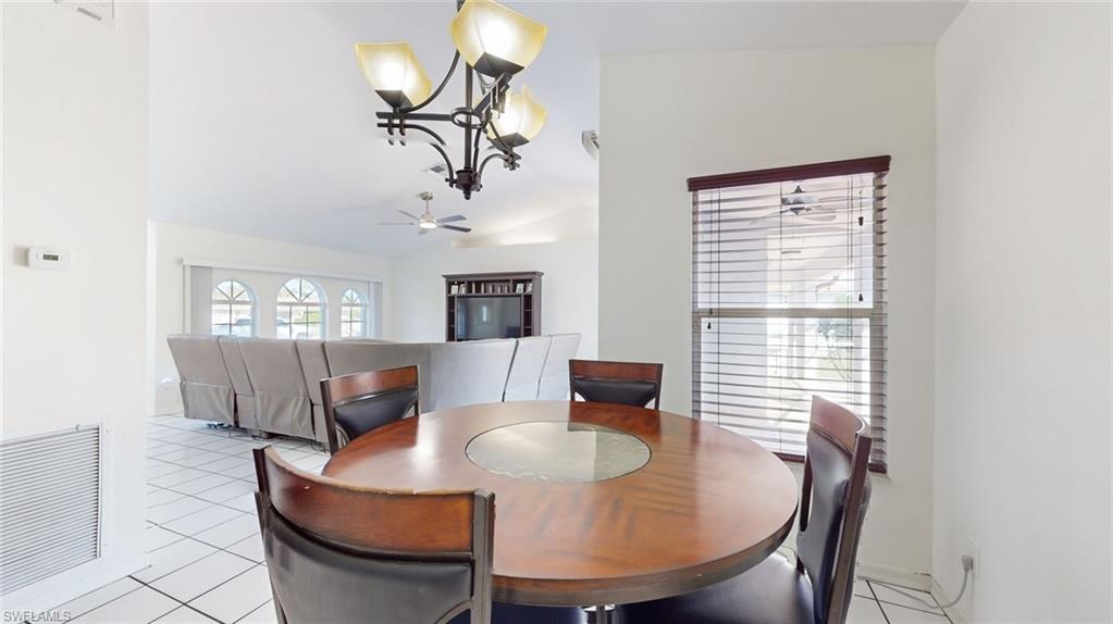 18249 Lee Road Fort Myers, FL 33967 - Photo 8 of 31 a living room with furniture a chandelier and a window