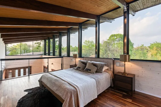 a view of backyard with large trees and wooden floor