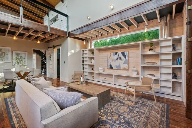 a living room with furniture and a potted plant