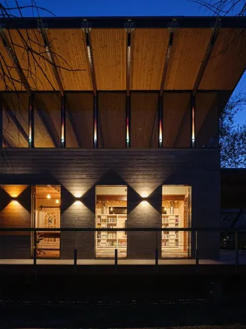 a view of a kitchen with kitchen island granite countertop wooden floor and a view of living room
