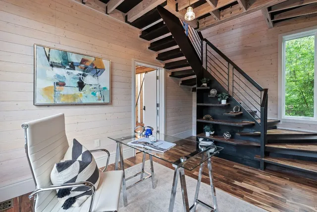 a living room with furniture a rug and a large window