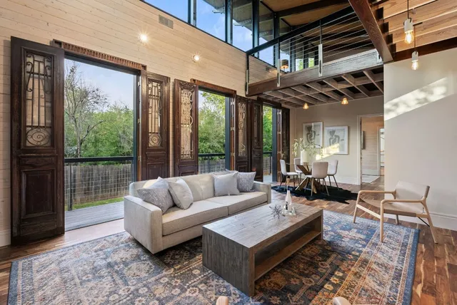 a large kitchen with a sink and a wooden floor