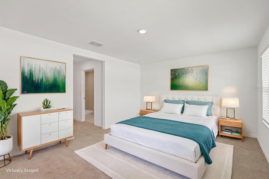 2642 Sunray Venus Way Ruskin, FL 33570 - Photo 16 of 30 a bedroom with a bed and a flat screen tv