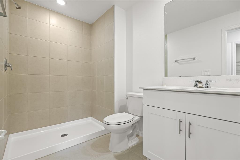 2642 Sunray Venus Way Ruskin, FL 33570 - Photo 19 of 30 a bathroom with a sink a toilet and shower