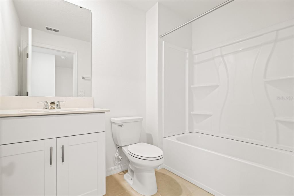 2642 Sunray Venus Way Ruskin, FL 33570 - Photo 23 of 30 a bathroom with a sink a toilet and shower