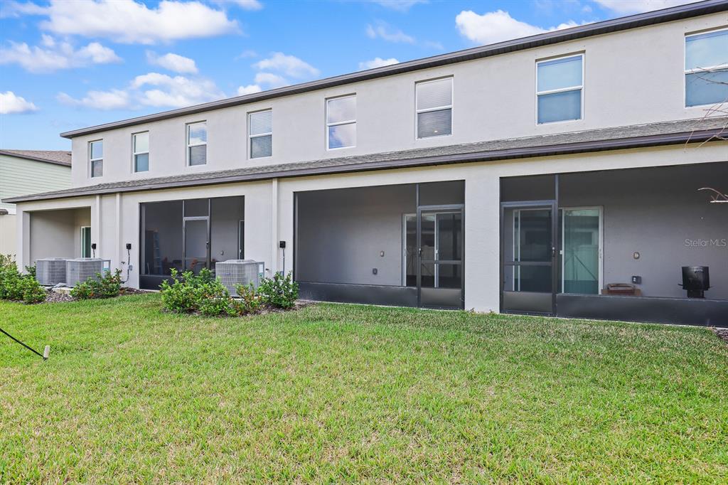 2642 Sunray Venus Way Ruskin, FL 33570 - Photo 28 of 30 a view of a house with brick walls and a yard with a large tree
