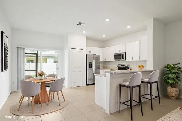 a kitchen with stainless steel appliances a refrigerator sink and microwave