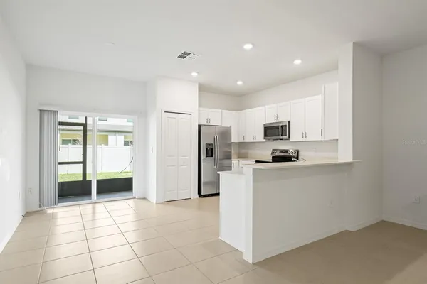 a kitchen with cabinets stainless steel appliances and a counter space