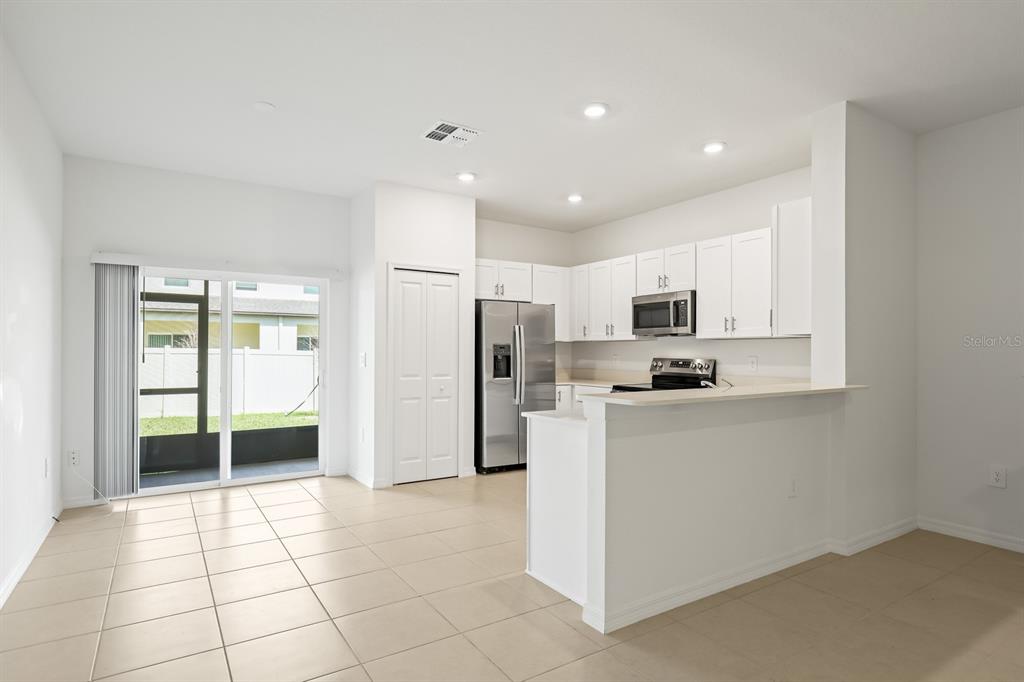 2642 Sunray Venus Way Ruskin, FL 33570 - Photo 8 of 30 a kitchen with stainless steel appliances a refrigerator sink and microwave