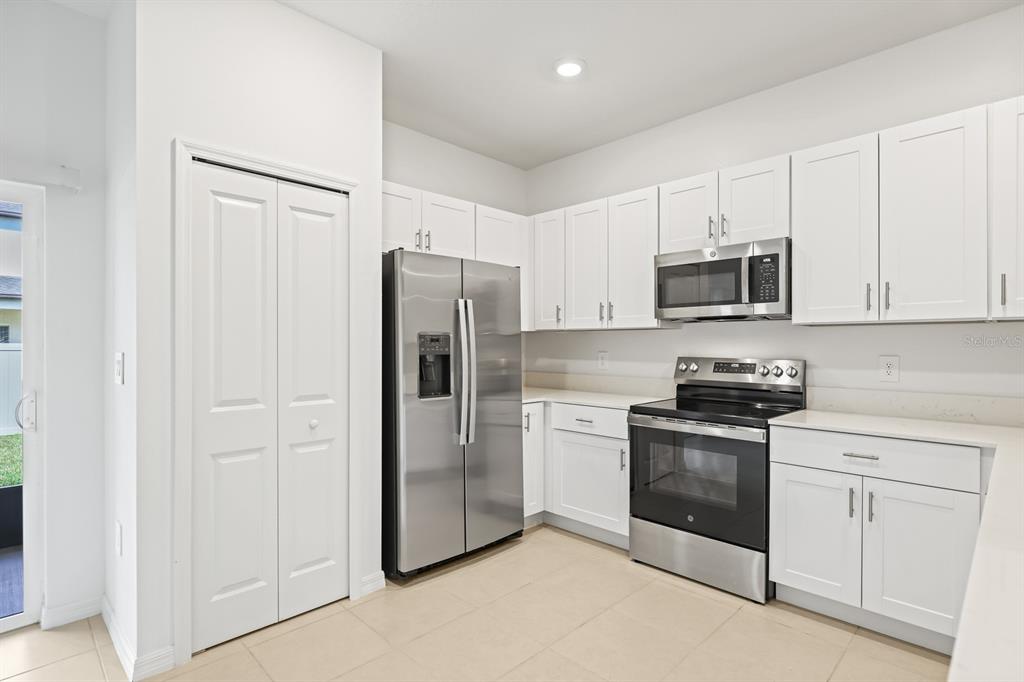 2642 Sunray Venus Way Ruskin, FL 33570 - Photo 9 of 30 a kitchen with cabinets stainless steel appliances and a counter space