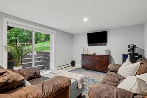 a living room with furniture and a potted plant