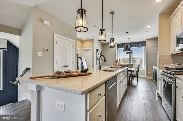 a kitchen with stainless steel appliances a sink stove and refrigerator