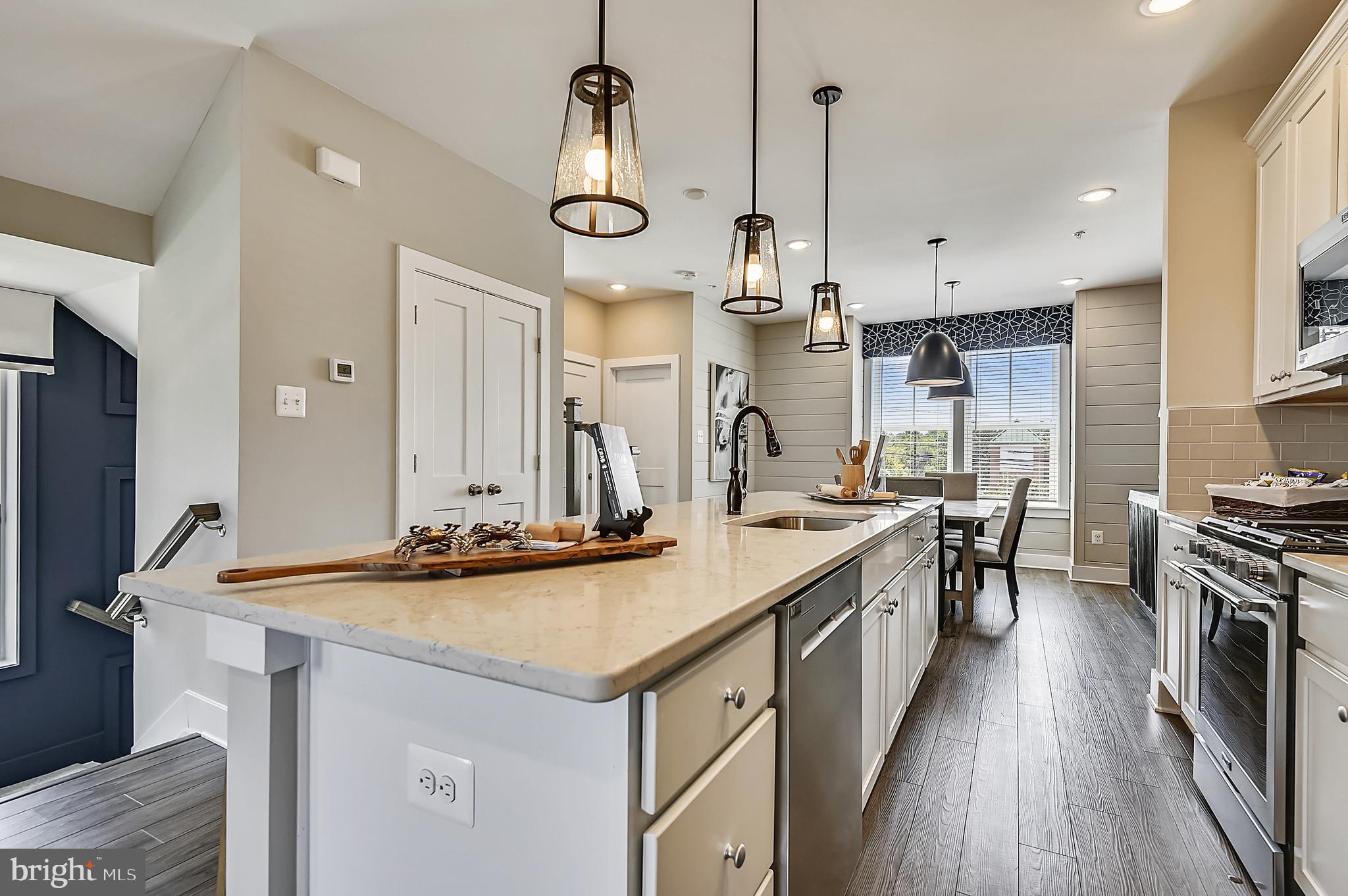 16601 Breezeway Alley Accokeek, MD 20607 - Photo 11 of 34 a kitchen with stainless steel appliances a sink stove and refrigerator