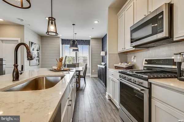a kitchen with a stove a sink and a microwave