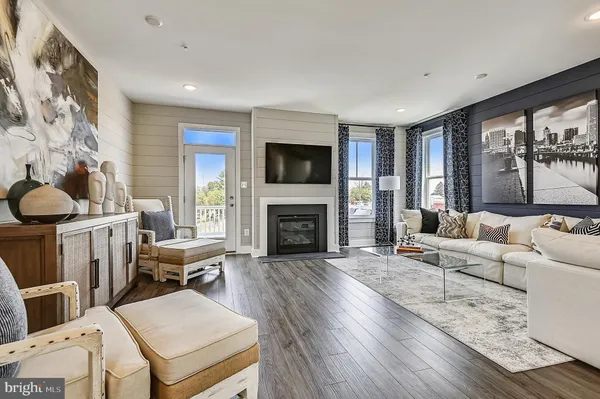 a living room with furniture a fireplace and a flat screen tv