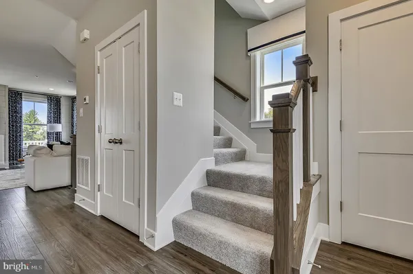 a view of entryway and hall with wooden floor