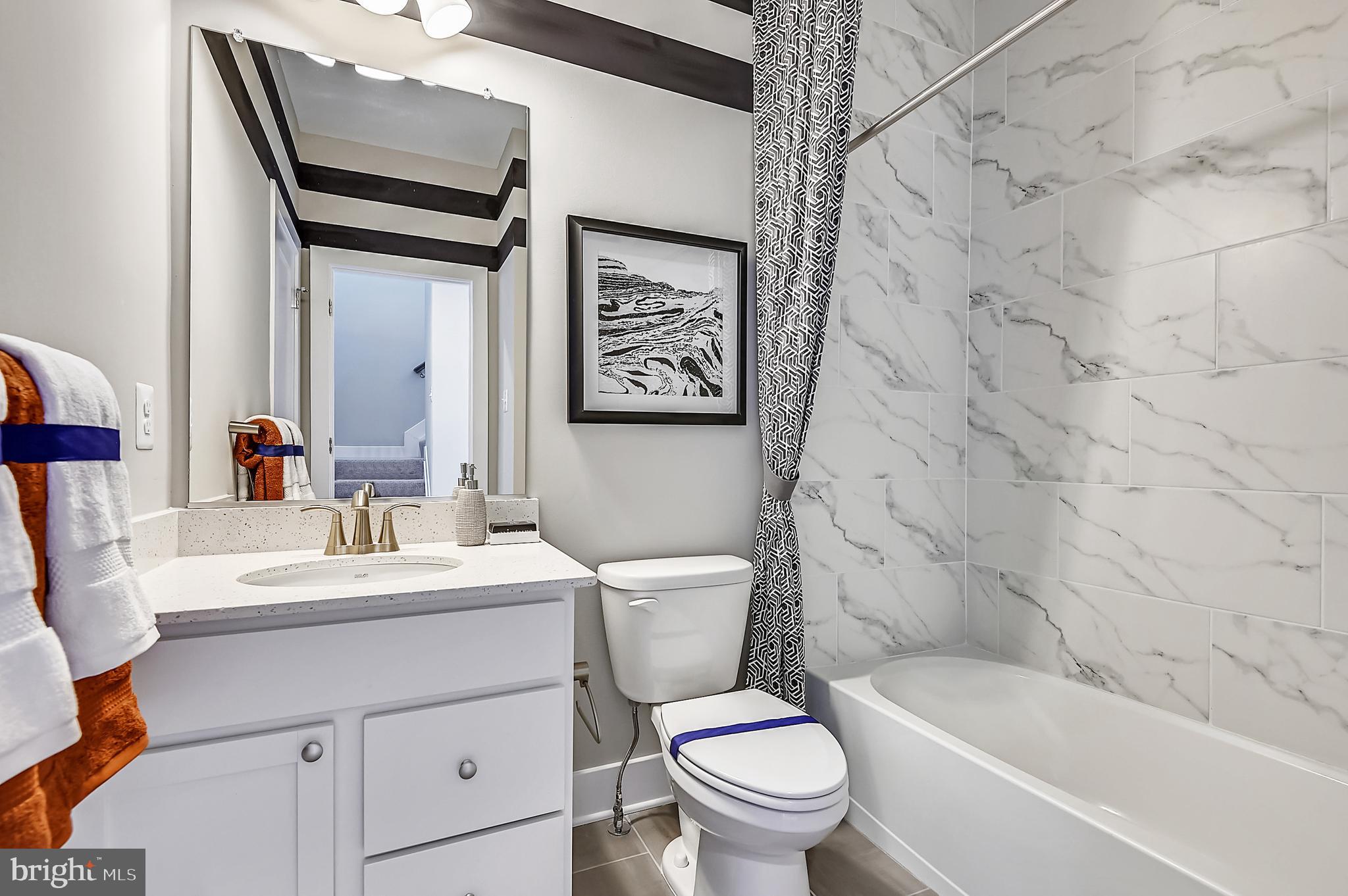 16601 Breezeway Alley Accokeek, MD 20607 - Photo 21 of 34 a bathroom with a toilet sink vanity tub and shower