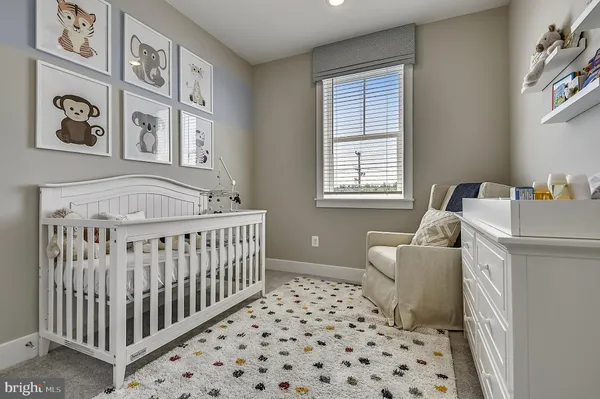 a bedroom with furniture and baby crib