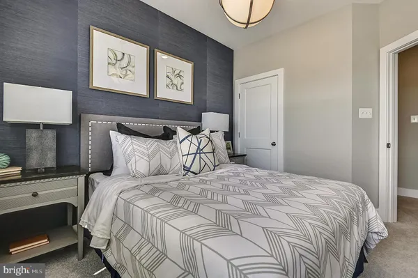 a bedroom with a bed and a potted plant