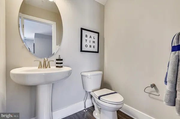 a bathroom with a toilet a sink and mirror