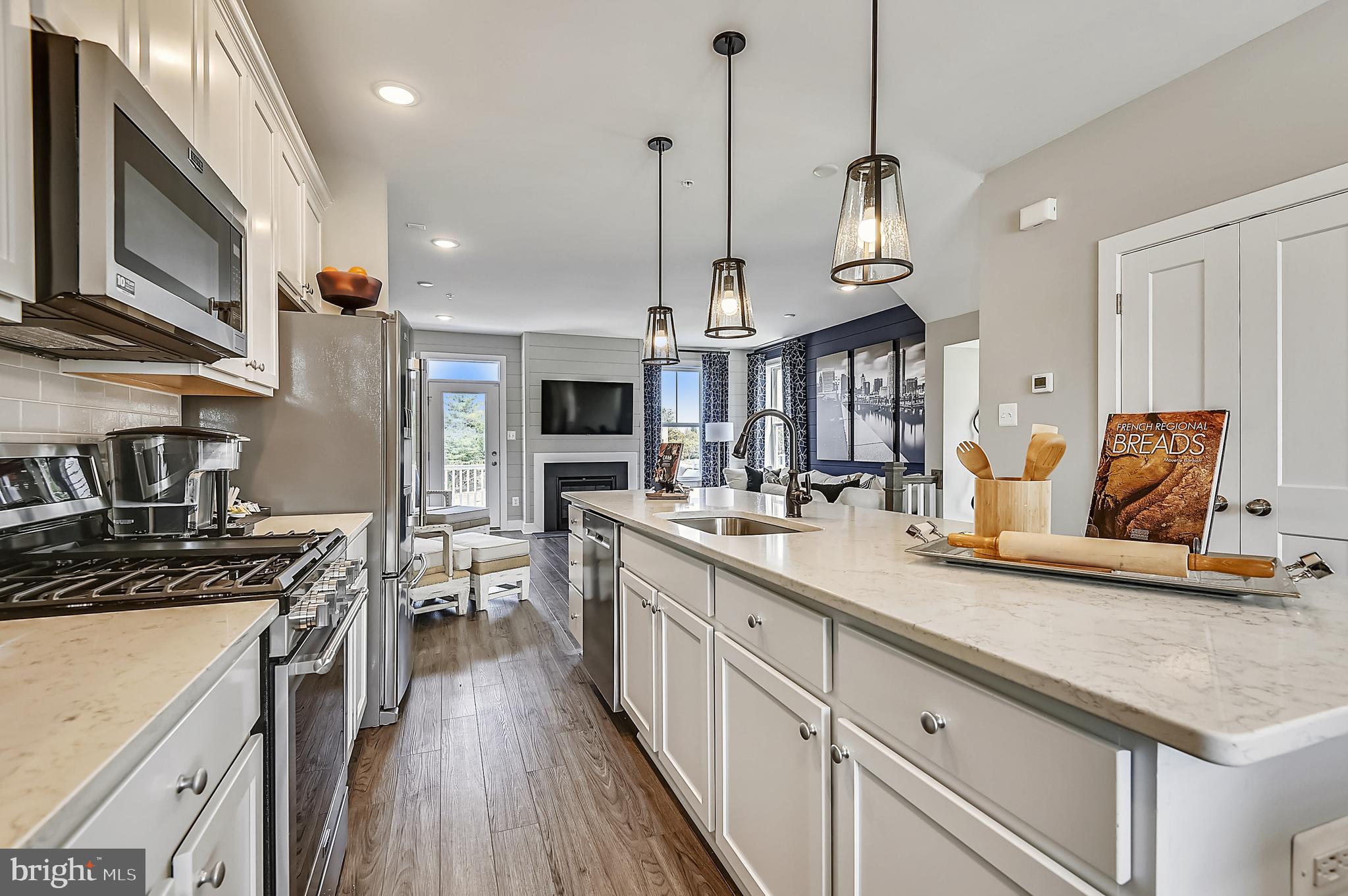 16601 Breezeway Alley Accokeek, MD 20607 - Photo 8 of 34 a kitchen with stainless steel appliances granite countertop a sink a stove and a wooden floors