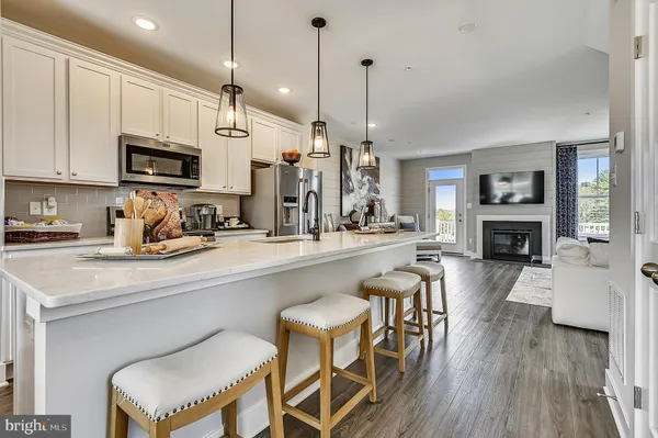 a kitchen with a table chairs refrigerator and cabinets