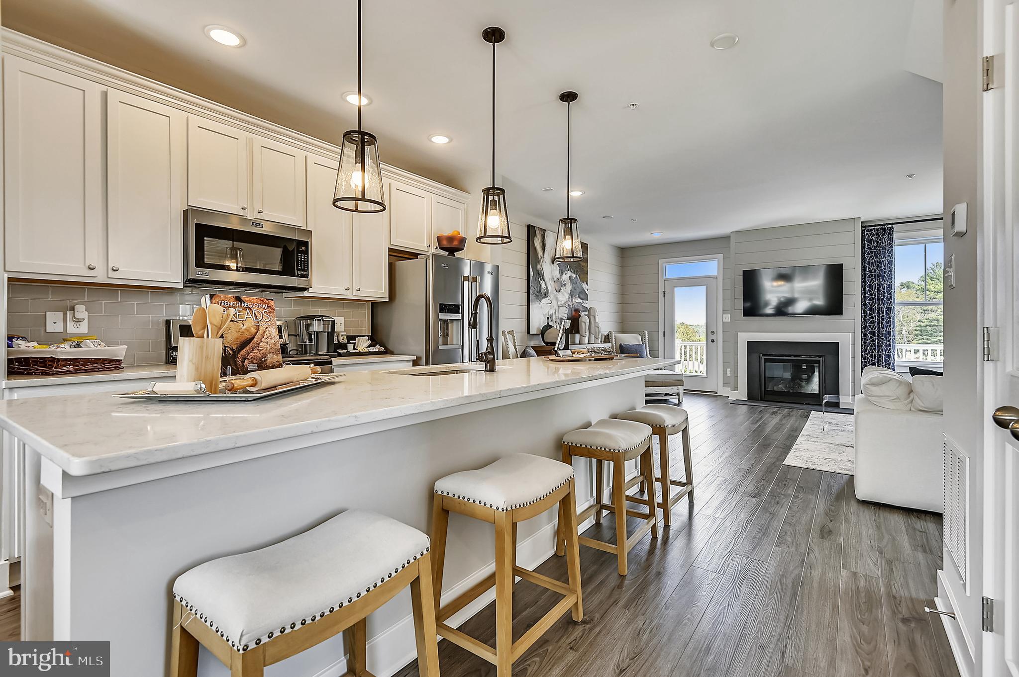 16601 Breezeway Alley Accokeek, MD 20607 - Photo 9 of 34 a kitchen with a table chairs refrigerator and cabinets