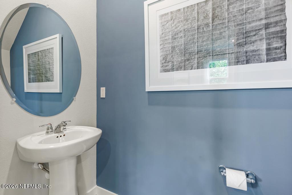 10698 Waterfield Road Jacksonville, FL 32210 - Photo 16 of 38 a bathroom with a sink and a mirror