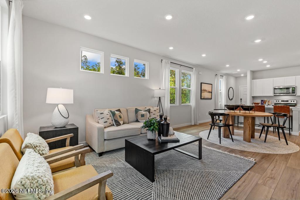 10698 Waterfield Road Jacksonville, FL 32210 - Photo 19 of 38 a living room with furniture kitchen view and a table