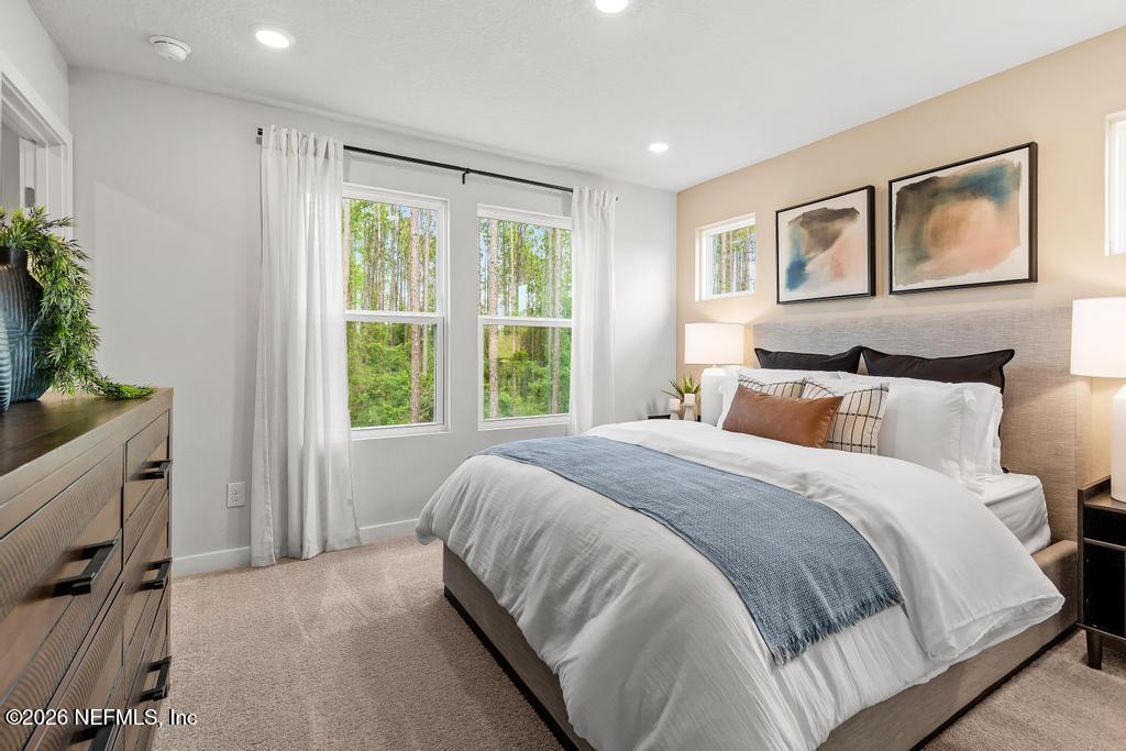 10698 Waterfield Road Jacksonville, FL 32210 - Photo 23 of 38 a bedroom with a large bed and a window