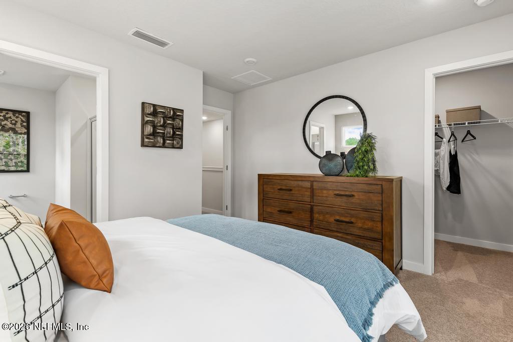 10698 Waterfield Road Jacksonville, FL 32210 - Photo 27 of 38 a bedroom with a bed and a dresser