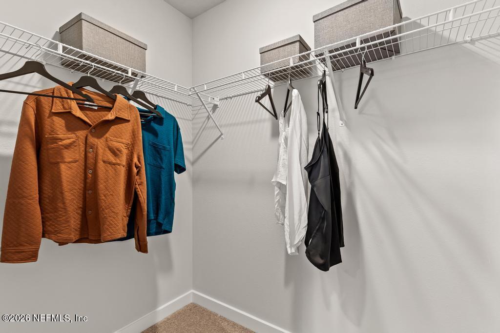 10698 Waterfield Road Jacksonville, FL 32210 - Photo 28 of 38 a view of walk in closet with clothes and shoes