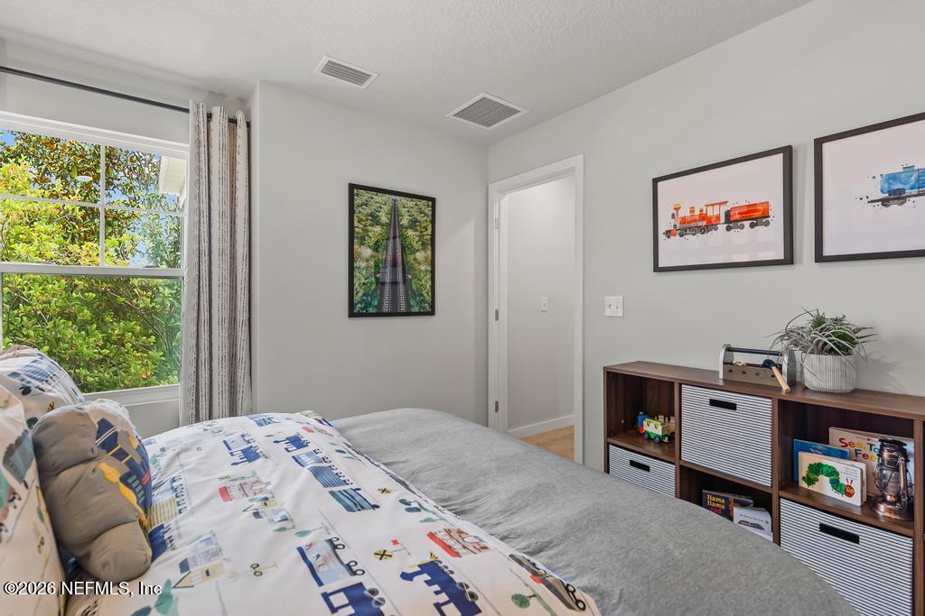10698 Waterfield Road Jacksonville, FL 32210 - Photo 32 of 38 a bedroom with a bed and a window