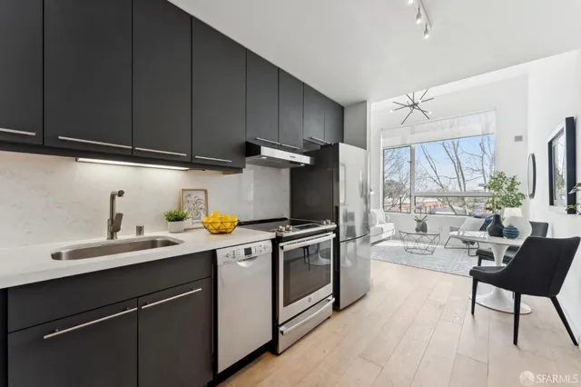 a kitchen with a sink a stove cabinets and a window