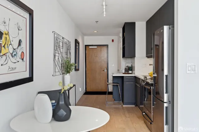 a living room with stainless steel appliances kitchen island granite countertop furniture a sink and a window
