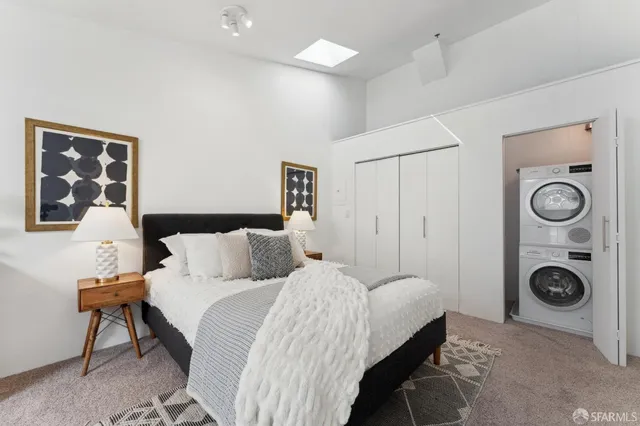 a bedroom with a bed and lamp