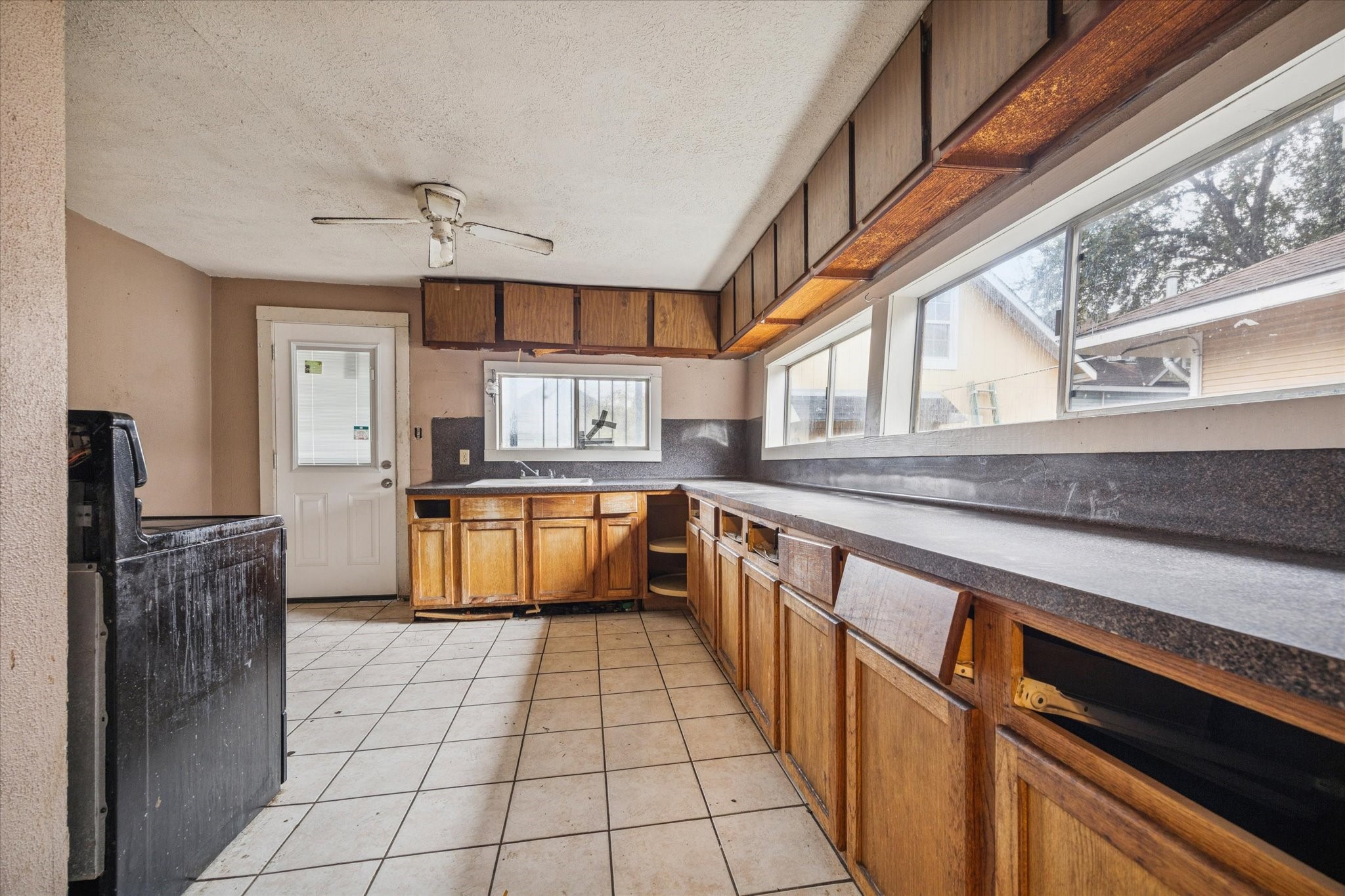 2906 Garrow Street Houston, TX 77003 - Photo 6 of 18 a kitchen with stainless steel appliances granite countertop a sink and cabinets