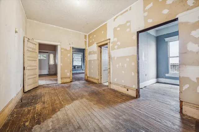 a view of a room with wooden floor and a bathroom