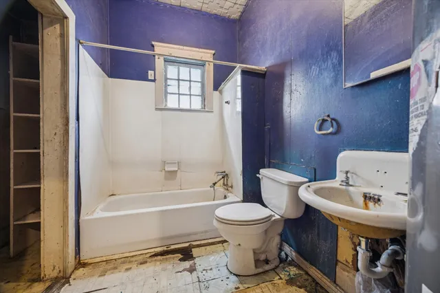 a bathroom with a toilet and a bathtub