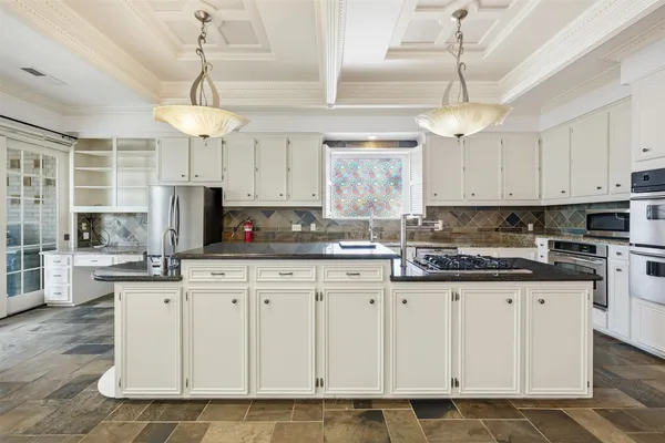 a kitchen with granite countertop white cabinets and white appliances