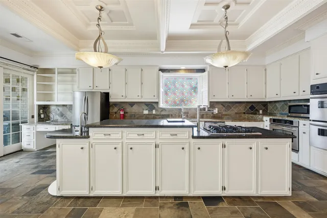 a kitchen with granite countertop white cabinets and white appliances