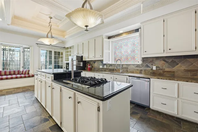 a kitchen with stainless steel appliances granite countertop a stove and cabinets