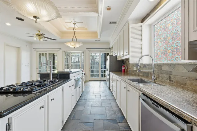a large kitchen with stainless steel appliances granite countertop a lot of counter space and a large window