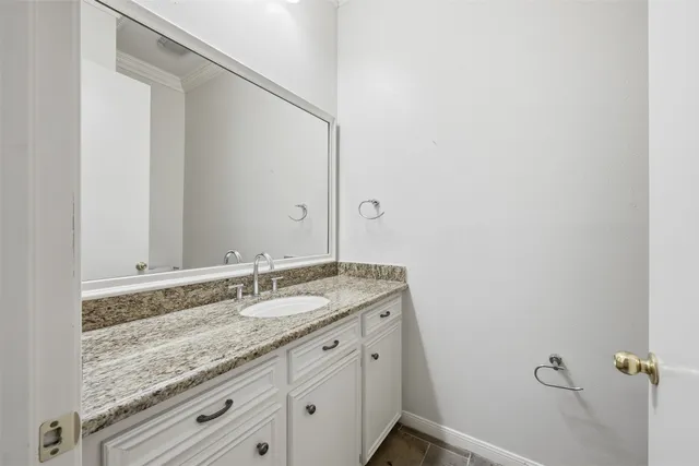 a bathroom with a granite countertop sink and mirror