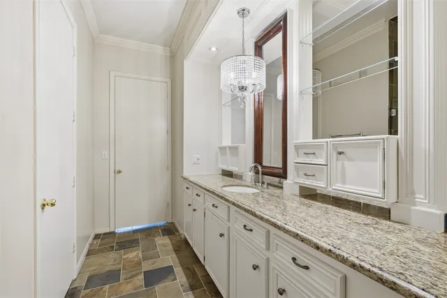 a room with white cabinets and wooden floor