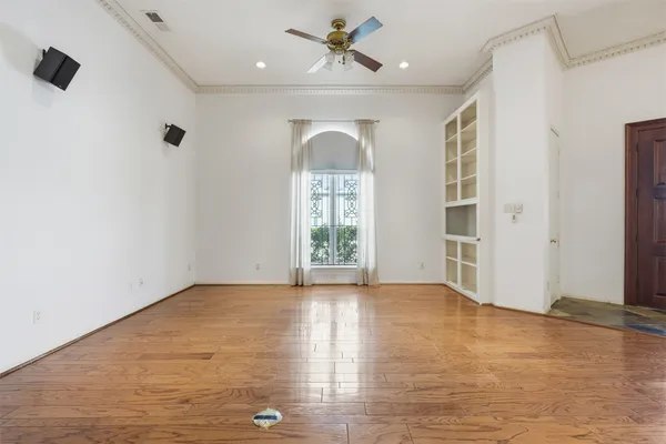 wooden floor in an empty room with a window