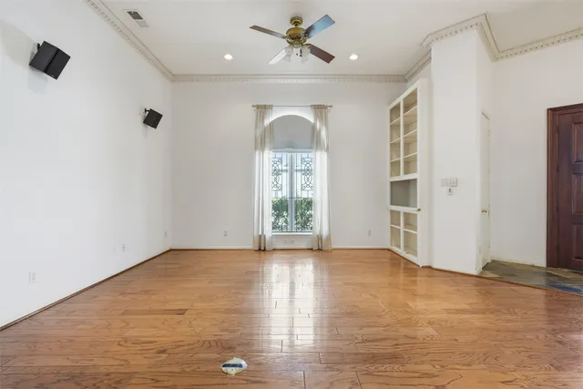 wooden floor in an empty room with a window