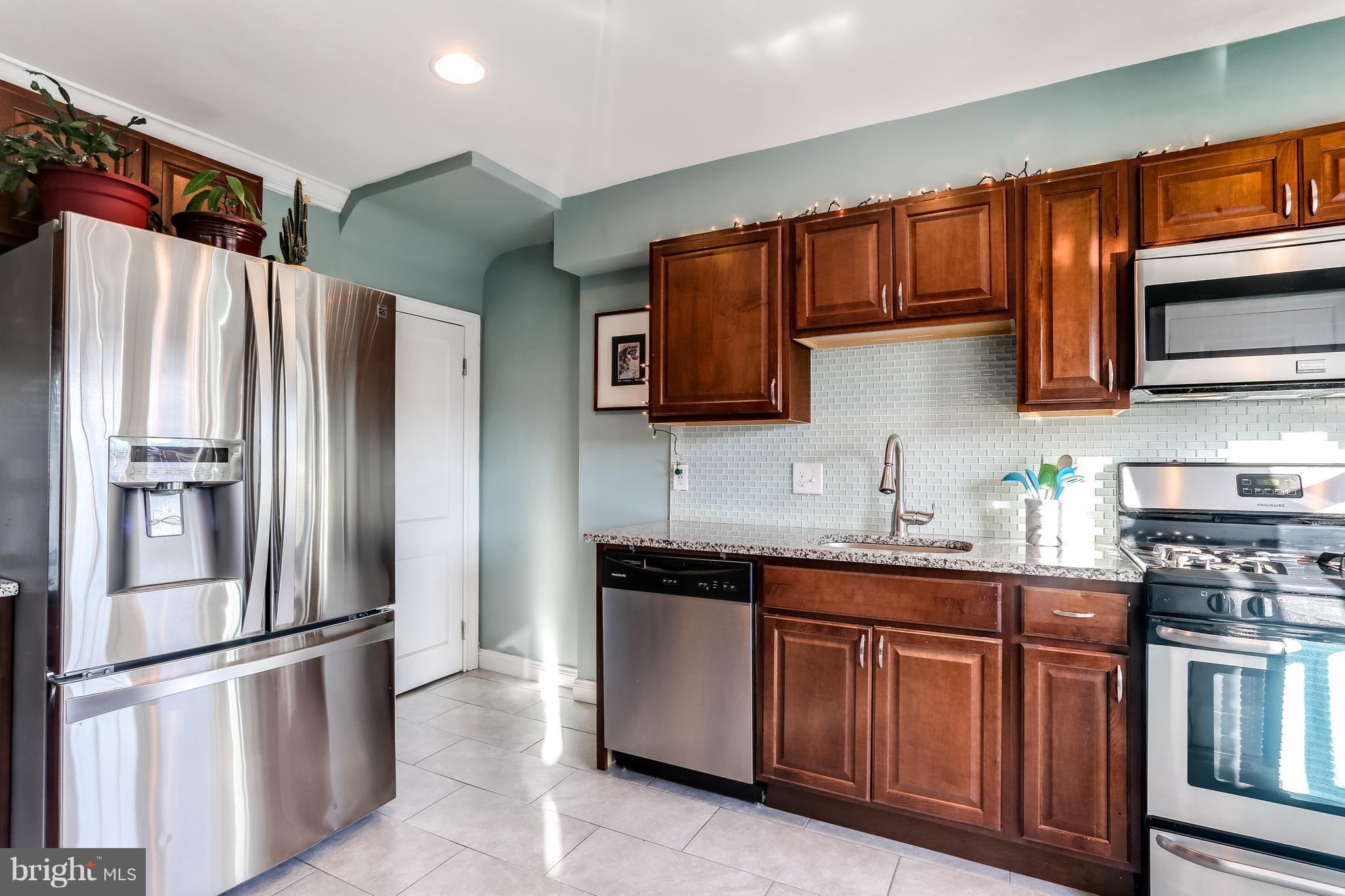 3909 Kimble Road Baltimore, MD 21218 - Photo 4 of 23 a kitchen with stainless steel appliances granite countertop a refrigerator sink and stove