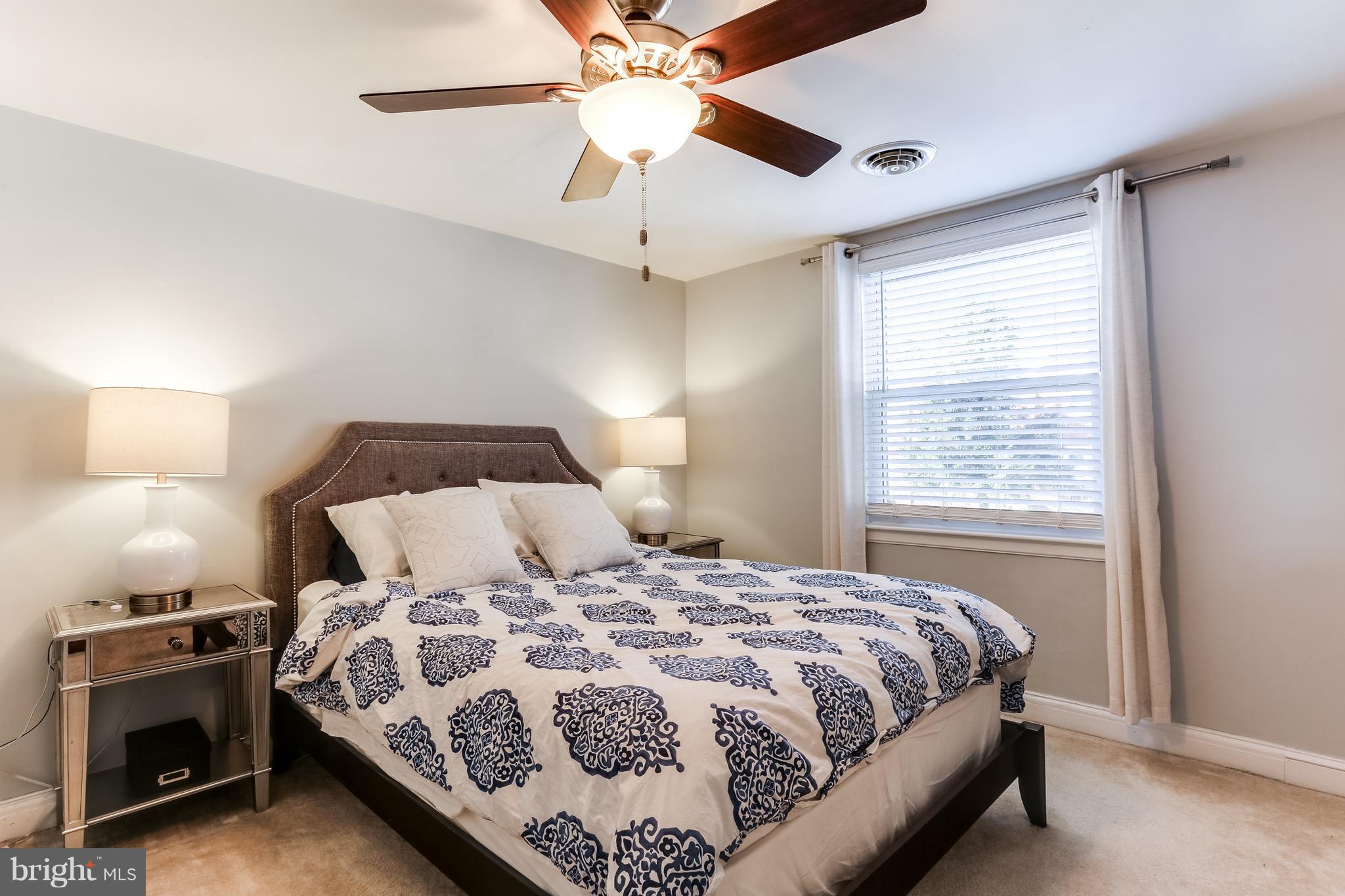 3909 Kimble Road Baltimore, MD 21218 - Photo 5 of 23 a bedroom with a bed and a chandelier